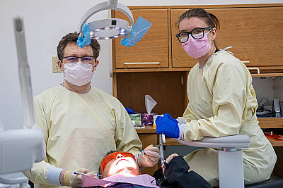 Dr Baranjouk and Maria (Marichka)RDA performing dental treatment